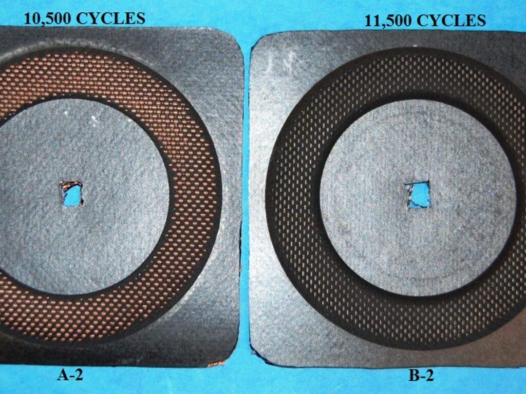 Comparison of two fabric samples after cyclic testing. The paint on one sample is significantly faded compared to the other.