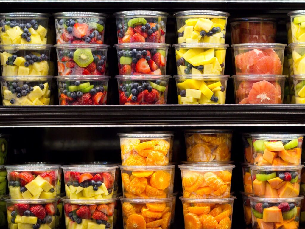 Shelves of packaged fruit slices in a supermarket.