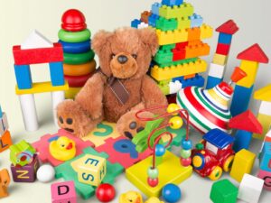Children's toys. Multi-colored blocks, blocks, tops, and a teddy bear.