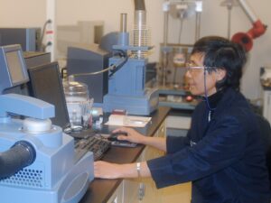 A chemist operates differential scanning calorimetry equipment for DSC analysis