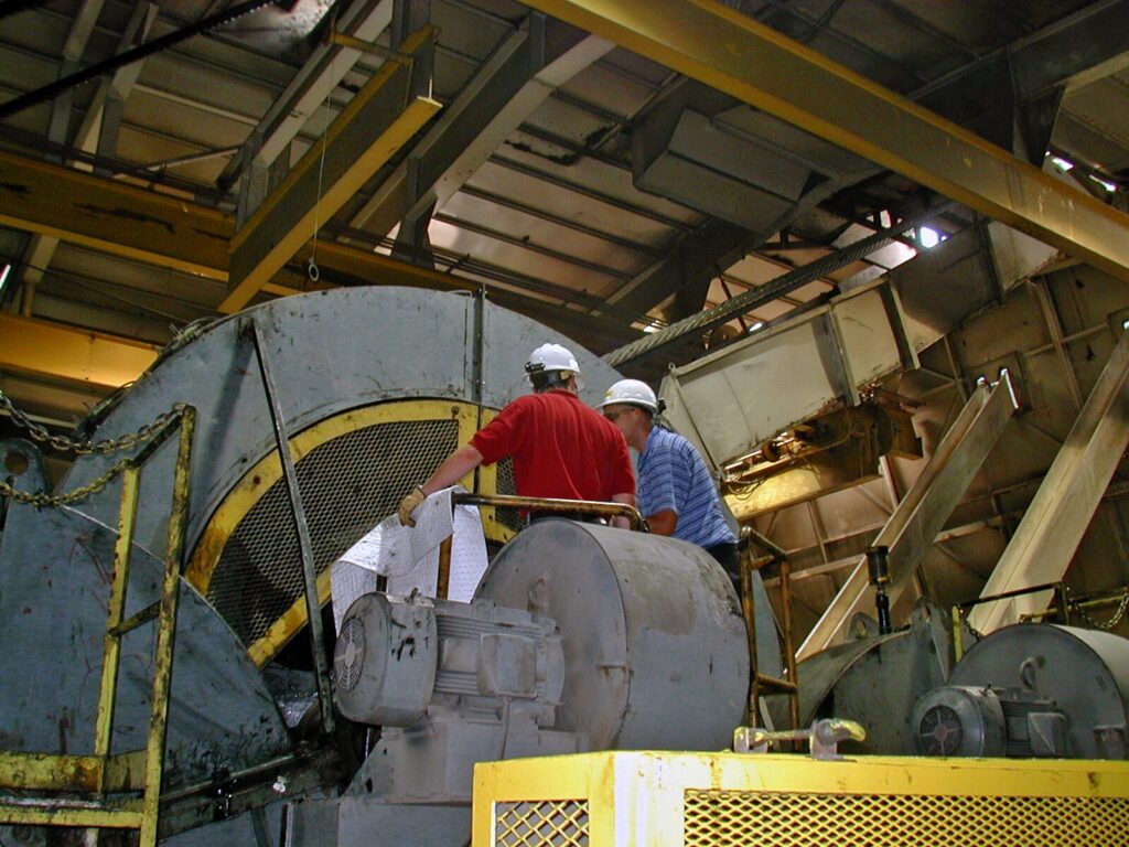 Two engineers discuss a failed industrial boiler