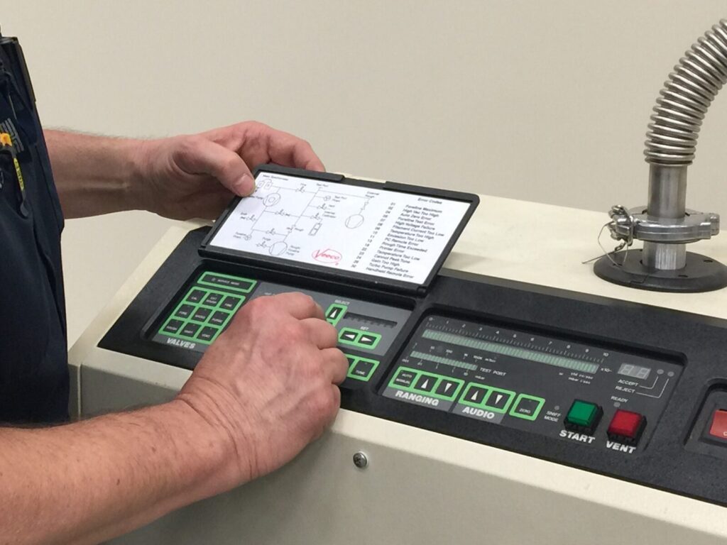 Technician performs helium leak testing
