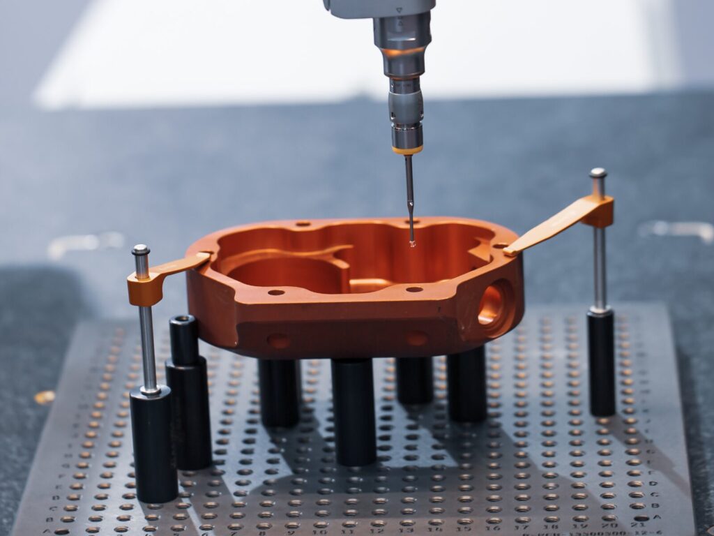 Close up on a manufactured part and a CMM probe