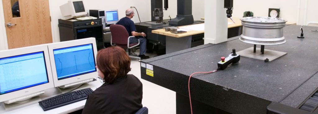 Technicians Performing a Dimensional Analysis on a Client Sample Using CMM