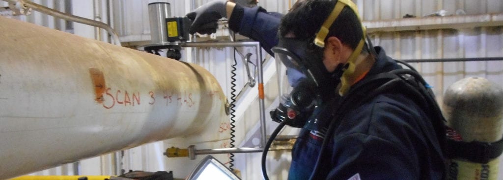 Expert performing nondestructive pipe inspection services