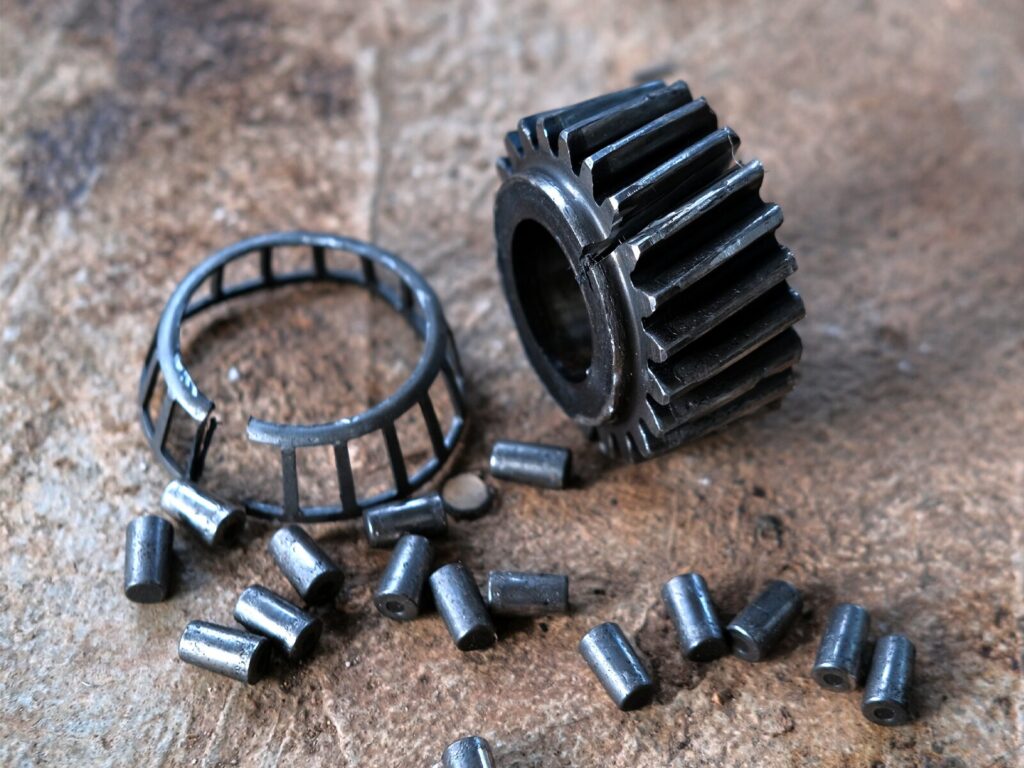 Disassembled and failed bearing and gear at a workshop