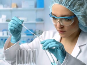 Chemist takes a liquid sample from a test tube