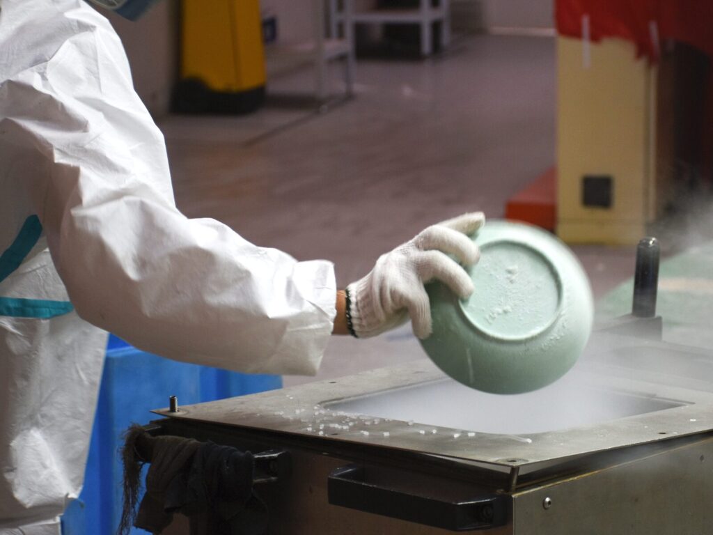 Forensic expert removes a bowl from refrigerated evidence storage