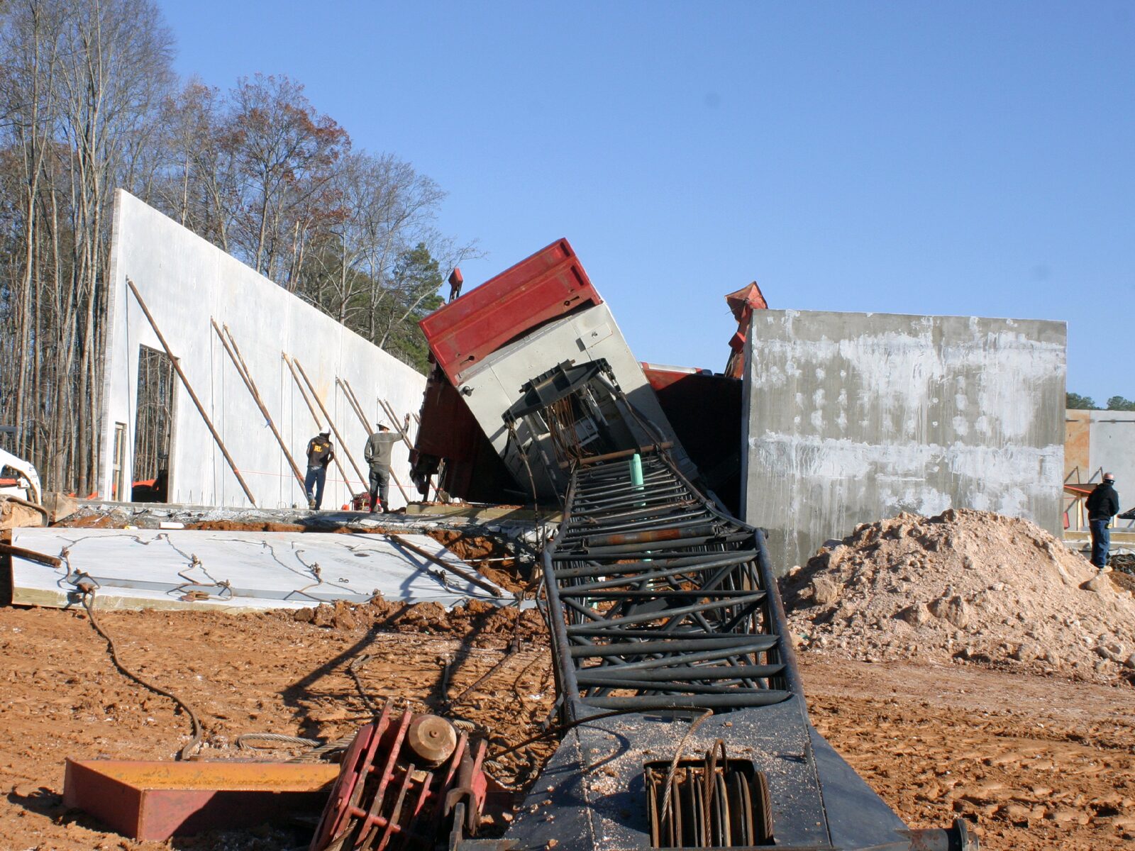 Aftermath of an industrial accident. A crane has fallen through the middle of a building under construction.