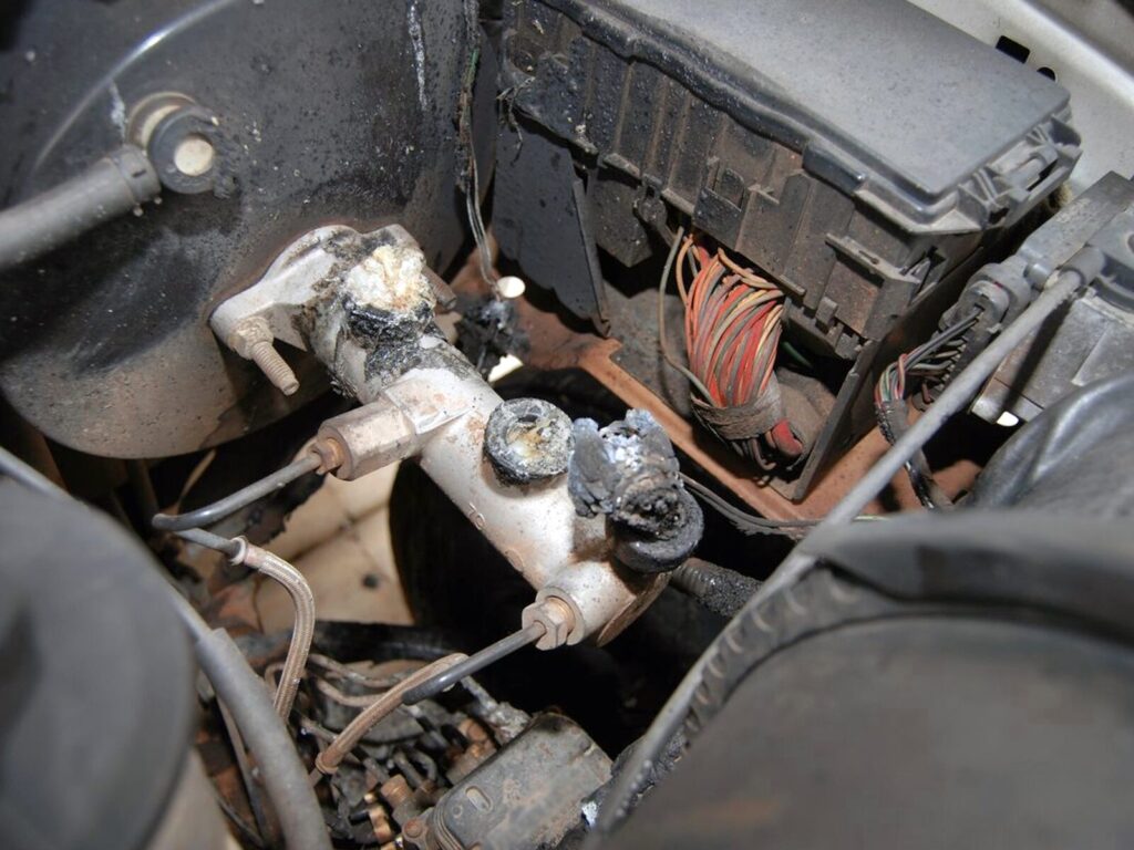 A damaged and dusty speed control deactivation switch in a vehicle