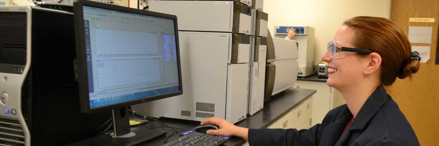 Chemist reviews chromatography results on a computer monitor