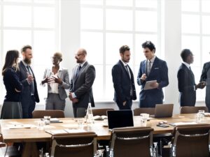 Experts gather in groups in a conference room.