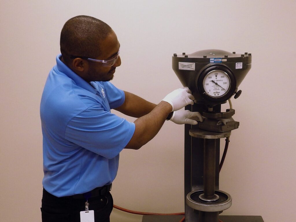 Technician sets up a sample for Brinell Hardness testing