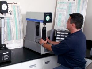 Technician performs hardness testing on a sample in our metallurgy lab.