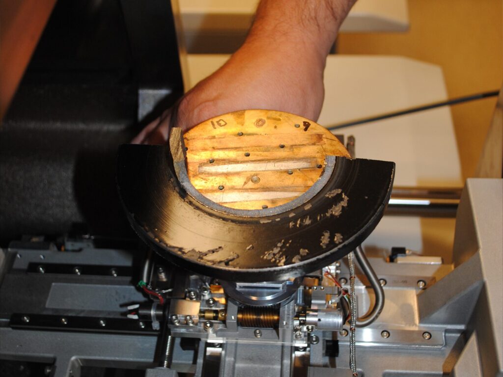Technician loads a sample for Scanning Electron Microscopy (SEM).