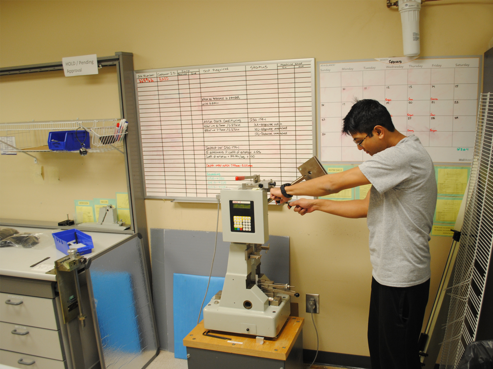 Technician working on pendulum ATS Uses to Perform Both Izod and Charpy Impact Testing