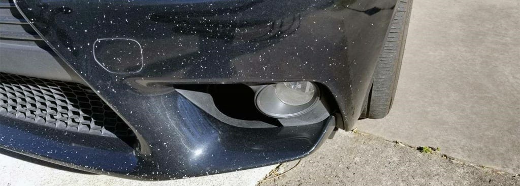 Car with coating damage from road debris like gravel
