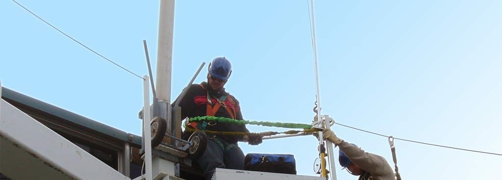 Engineers Using Rope Access to Check the Condition of a Roof Davit