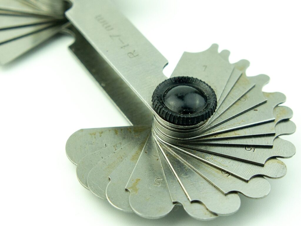 Focus on a radius gage against a white background