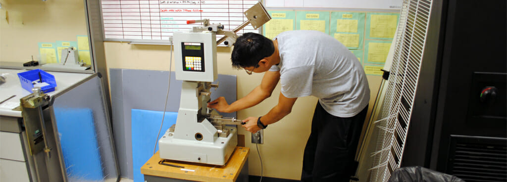 Technician Preparing Plastic Sample for Izod Impact Test
