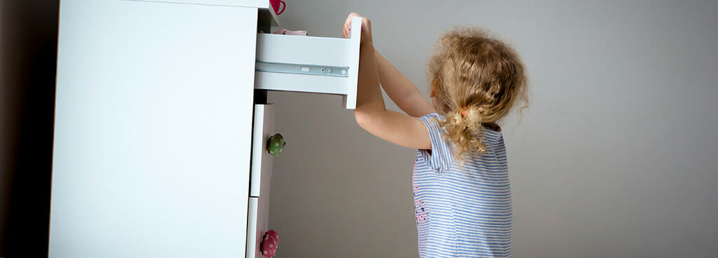 child climbing an unstable piece of furniture