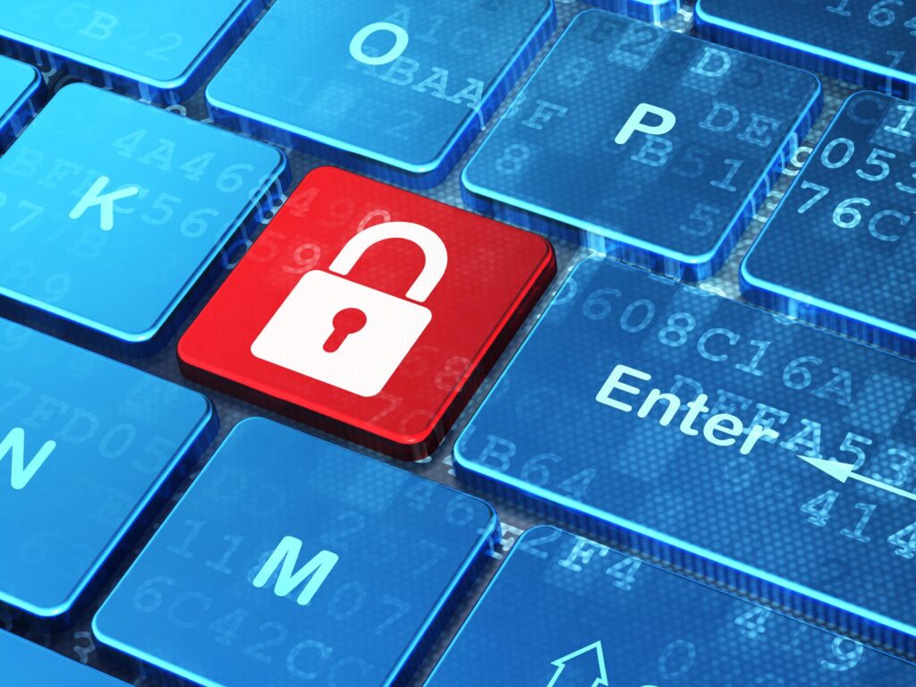 Information technology security concept: a keyboard with a red button with a lock symbol
