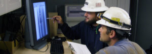 Technicians examining a radiograph