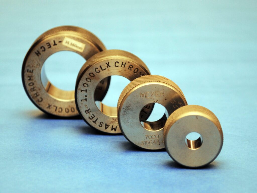 A set of Meyer ring gages against a blue background