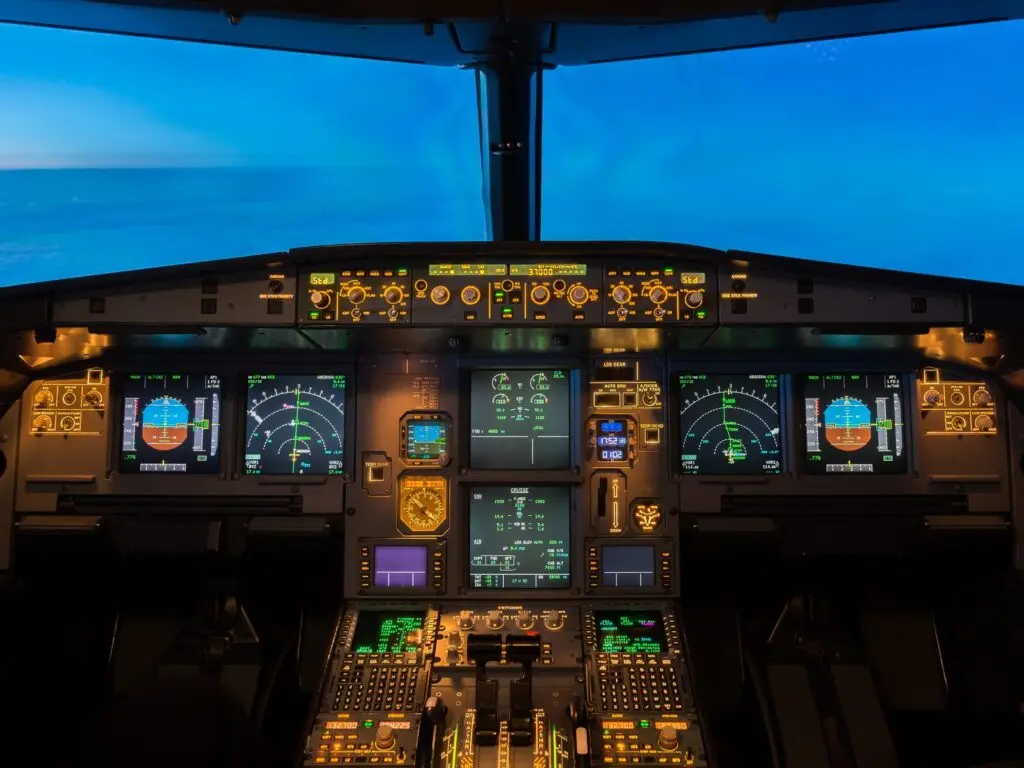 Cockpit of an airplane with a glowing panel of avionic indicators