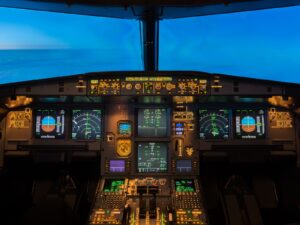Cockpit of an airplane with a glowing panel of avionic indicators