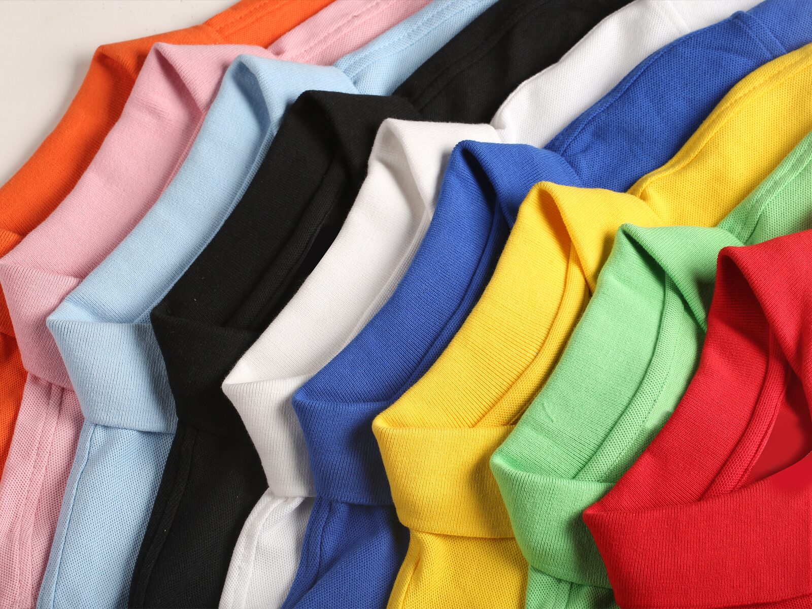 A stack of multicolored shirts that have passed consumer product testing