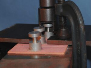 Pink coat of paint during an adhesion pull-off test