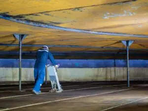 Technician walks along the floor of a large industrial tank