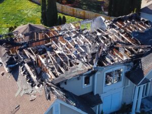 Aerial view of a residential building after an explosion. The roof has been blown off.