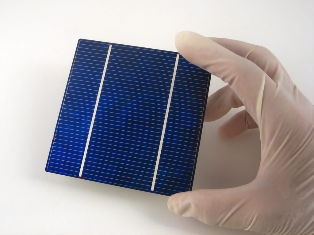 Gloved hand holds a solar cell semiconductor