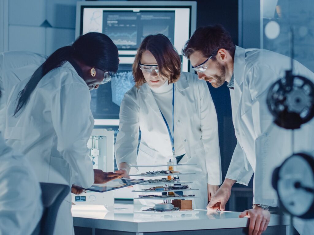 Three forensic engineers gather around a table