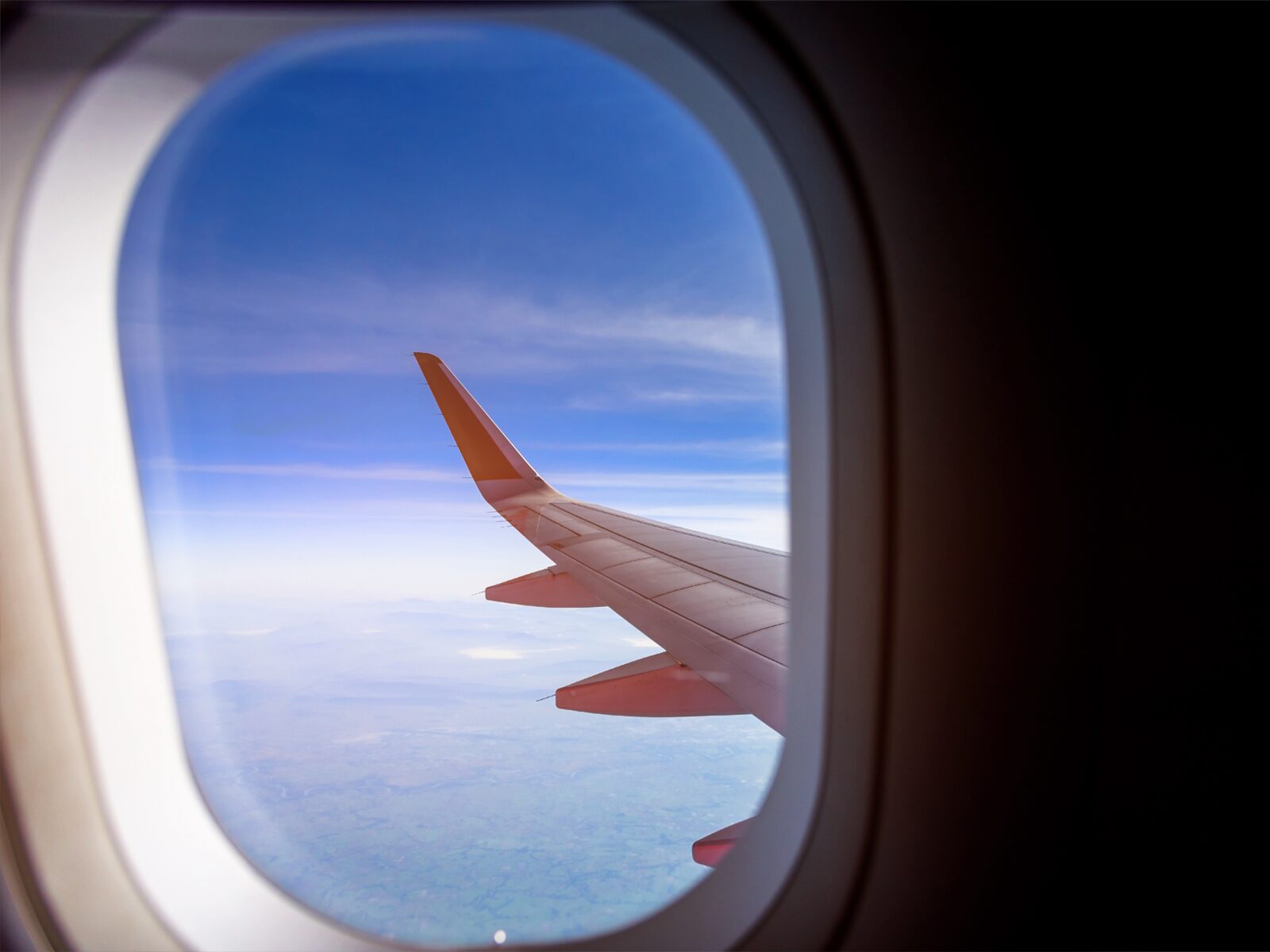 View of an airplane wing from inside the cabin