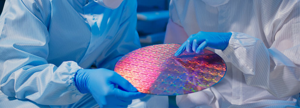 Two Scientists Inspecting A Semiconductor Wafer