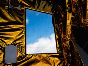 Solar panel for a space weather satellite on top of multilayer insulation blanket