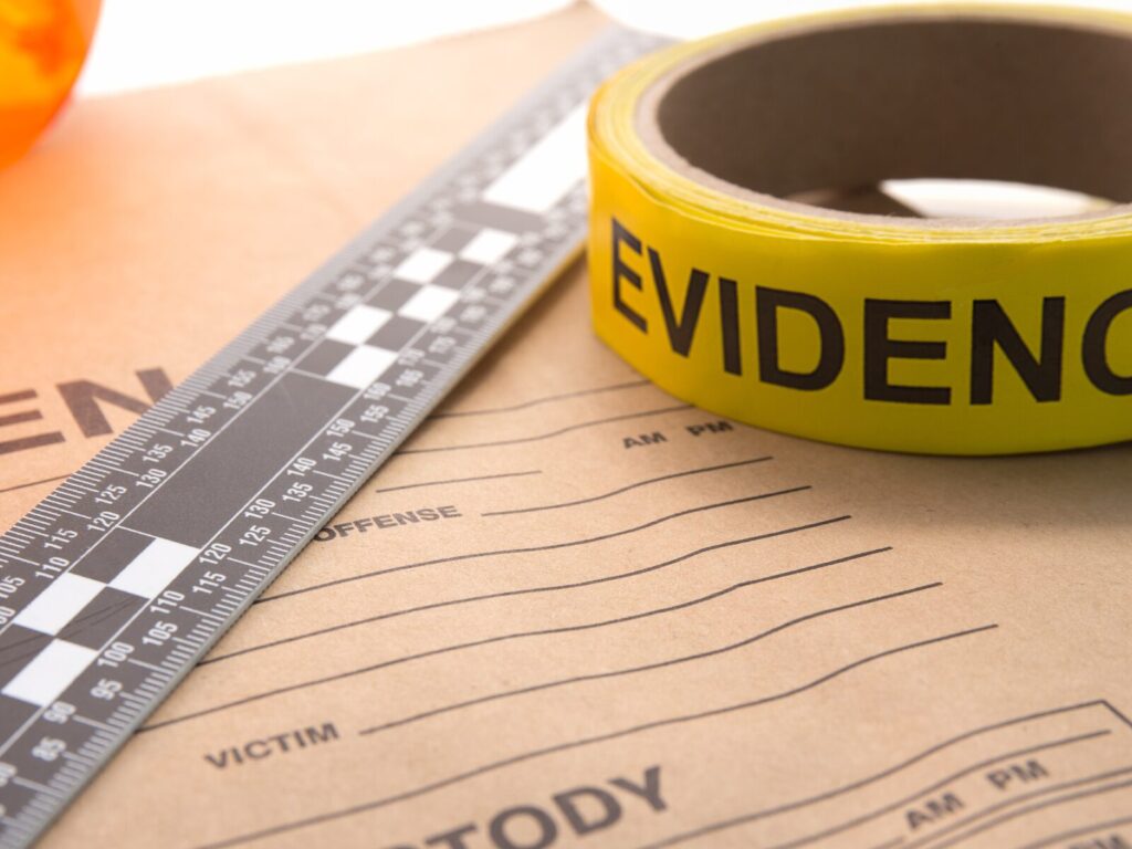 Forensic documents, ruler, and evidence tape