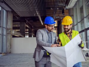 Two engineers in a building during construction