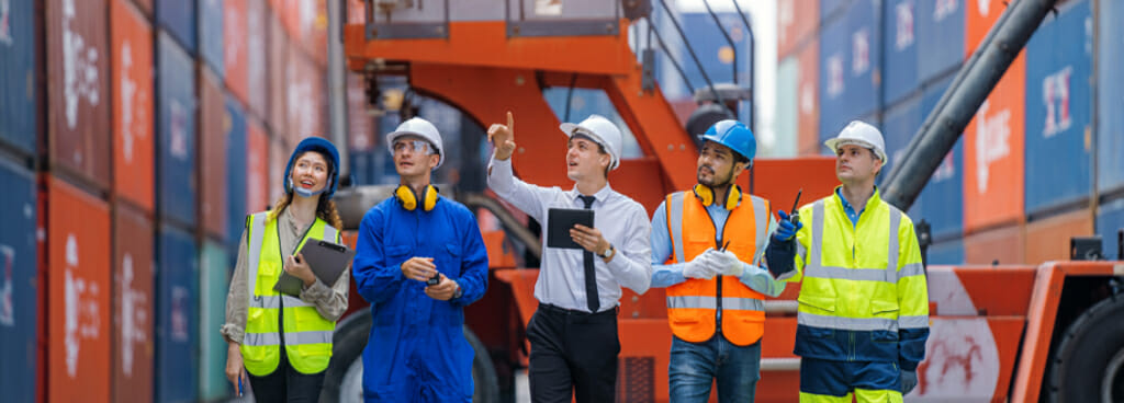 Five forensic engineering consultants examine a shipyard.
