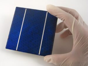 Gloved hand holds a hand-sized semiconductor