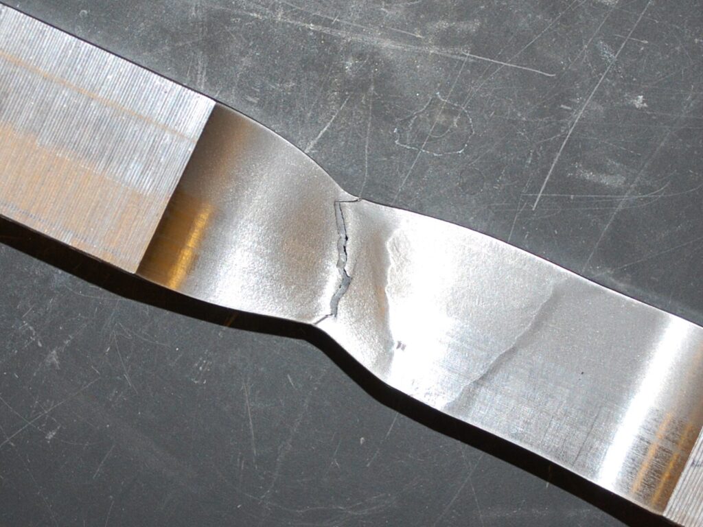 Weld coupon showing signs of tensile failure