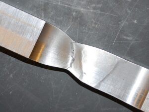 Weld coupon showing signs of tensile failure