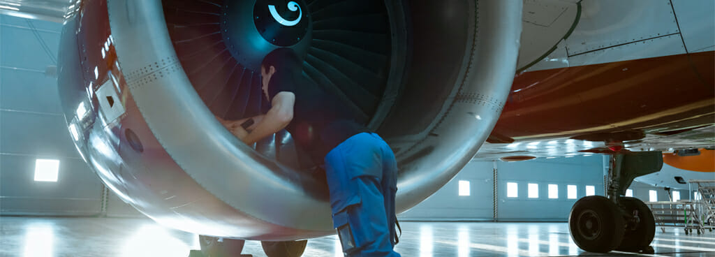 NDI technician inspecting aircraft using nondestructive inspection methods.