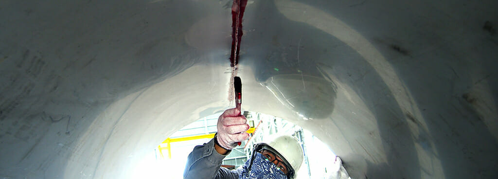 A technician performs NDI Liquid Penetrant Testing