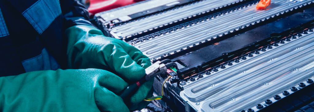 A technician removes an EV module for battery abuse testing.
