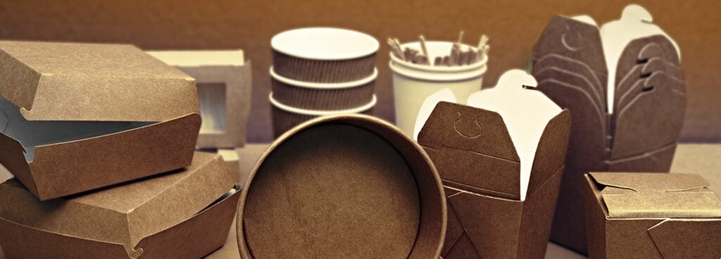 A collection of single-use food containers. There are stacks of boxes, bowls, and cups.