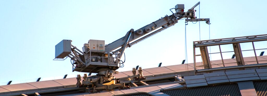 A large BMU moves across the incline of an industrial roof.